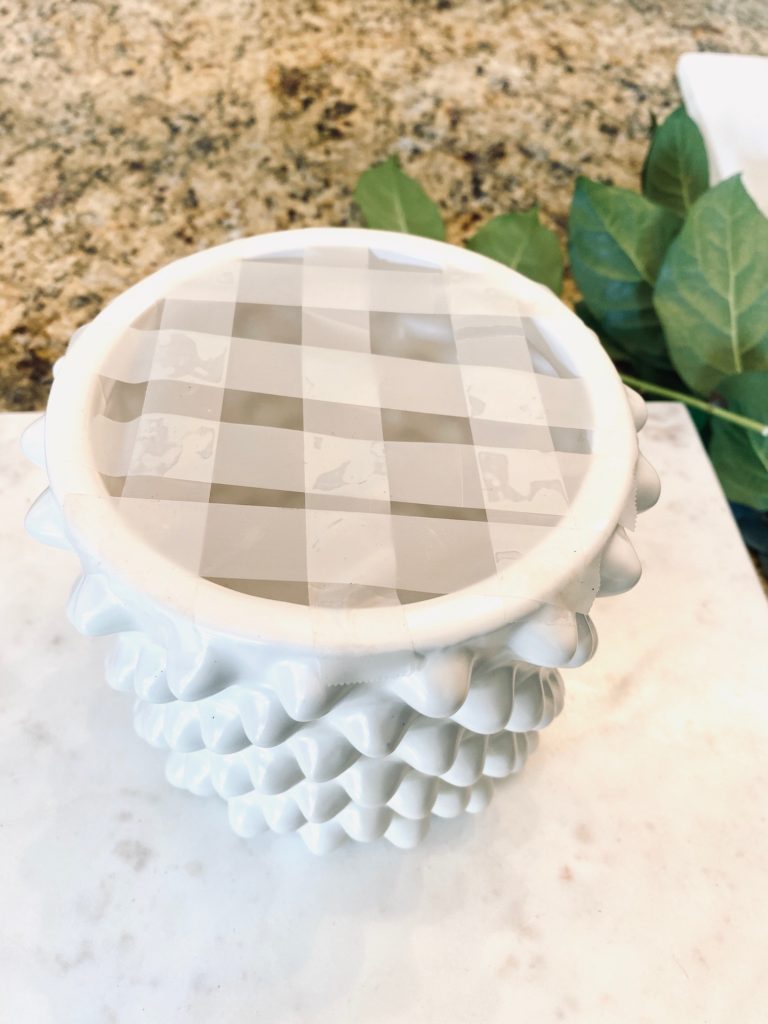 white knobby jar with tape grid