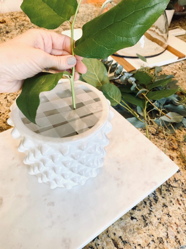 Floral arrangement hack of kobby white jar with tape grid for stems